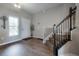 Entryway featuring hardwood floors, staircase with iron railings and a bright window at 2469 Stapleford Pl, Wesley Chapel, FL 33543