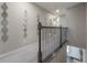 Hallway with decorative mirrors and a wooden staircase at 2469 Stapleford Pl, Wesley Chapel, FL 33543