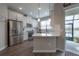 Modern kitchen with stainless steel appliances, white cabinets, and granite countertops, and patio access at 2469 Stapleford Pl, Wesley Chapel, FL 33543