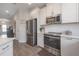 Bright kitchen with stainless steel appliances and white cabinets, and lots of storage at 2469 Stapleford Pl, Wesley Chapel, FL 33543