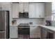 Bright kitchen with stainless steel appliances, white cabinetry, and modern fixtures at 2469 Stapleford Pl, Wesley Chapel, FL 33543