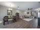 Spacious living room and dining area with hardwood floors, modern lighting, and comfortable seating at 2469 Stapleford Pl, Wesley Chapel, FL 33543