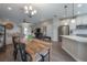 Open floor plan with dining area, kitchen, and living room featuring modern decor and neutral tones at 2469 Stapleford Pl, Wesley Chapel, FL 33543