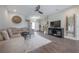 Spacious living room featuring hardwood floors, large sectional sofa, and modern entertainment center at 2469 Stapleford Pl, Wesley Chapel, FL 33543