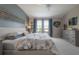Comfortable primary bedroom with a ceiling fan, view, and carpet at 2469 Stapleford Pl, Wesley Chapel, FL 33543