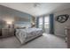 Comfortable primary bedroom with a ceiling fan, view, and carpet at 2469 Stapleford Pl, Wesley Chapel, FL 33543