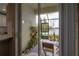 View from inside looking out onto a screened-in patio with a lake view beyond at 2469 Stapleford Pl, Wesley Chapel, FL 33543