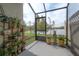 Charming screened patio with plants offering picturesque waterfront views at 2469 Stapleford Pl, Wesley Chapel, FL 33543