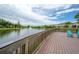 Scenic pond with a water fountain feature and lounge chairs at 2469 Stapleford Pl, Wesley Chapel, FL 33543