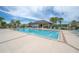 Community pool with a cabana and plenty of seating at 2469 Stapleford Pl, Wesley Chapel, FL 33543