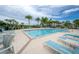 Resort-style pool area with lounge chairs and tropical landscaping at 2469 Stapleford Pl, Wesley Chapel, FL 33543