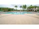 Resort-style pool area with ample seating and lush landscaping creating a relaxing atmosphere at 2469 Stapleford Pl, Wesley Chapel, FL 33543