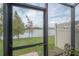 Tranquil water view from the screened patio area showcases the beautiful landscape at 2469 Stapleford Pl, Wesley Chapel, FL 33543