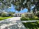 Beautifully landscaped home with manicured lawn, long driveway, and bright exterior paint at 3612 Cordgrass Dr, Valrico, FL 33596