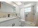 Bathroom featuring bright white vanity, toilet, and walk-in shower with grab bar at 3633 Odom Dr, New Port Richey, FL 34652