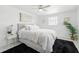 Bright bedroom featuring a plush bed, modern ceiling fan, and light gray flooring at 3633 Odom Dr, New Port Richey, FL 34652