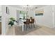 Dining room featuring modern light fixture, neutral decor, and view to the outside patio at 3633 Odom Dr, New Port Richey, FL 34652