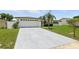 Single-story home with a large driveway and well-kept lawn at 3633 Odom Dr, New Port Richey, FL 34652