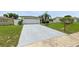 Single-story home with a large driveway and well-kept lawn at 3633 Odom Dr, New Port Richey, FL 34652