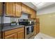 A charming kitchen featuring stainless steel appliances, and oak cabinets at 3633 Odom Dr, New Port Richey, FL 34652