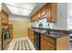 A classic kitchen with tile backsplash, countertop with stainless steel appliances at 3633 Odom Dr, New Port Richey, FL 34652