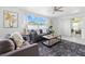 Well-lit living room featuring a neutral color palette, comfortable seating, and direct access to outdoor at 3633 Odom Dr, New Port Richey, FL 34652