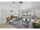 Bright living room featuring light wood floors, comfortable seating, and neutral decor at 3633 Odom Dr, New Port Richey, FL 34652