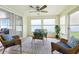Bright sunroom with wicker furniture, ceiling fan, and great natural light at 3633 Odom Dr, New Port Richey, FL 34652