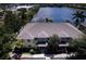 Scenic aerial view of the townhouse complex and the surrounding lake with lush vegetation at 3909 45Th W Ter # 102, Bradenton, FL 34210