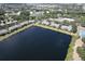 Aerial view of condo community featuring lake views, community pool, and mature trees at 3909 45Th W Ter # 102, Bradenton, FL 34210