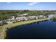 Scenic aerial view of lakeside condominiums with lush landscaping and community amenities on a sunny day at 3909 45Th W Ter # 102, Bradenton, FL 34210