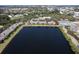 A condo community is highlighted on a large lake surrounded by lush greenery at 3909 45Th W Ter # 102, Bradenton, FL 34210