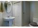 Cozy bathroom featuring a pedestal sink, toilet, and shower/tub combo with a patterned shower curtain at 3909 45Th W Ter # 102, Bradenton, FL 34210