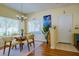 Bright dining area with laminate floors, decorative lighting, and views of the surrounding landscape at 3909 45Th W Ter # 102, Bradenton, FL 34210