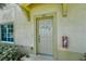Close-up of the front door, shows decorations, the unit number and a fire extinguisher at 3909 45Th W Ter # 102, Bradenton, FL 34210