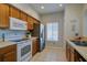 Functional kitchen with stainless steel appliances, tile flooring, and ample counter space at 3909 45Th W Ter # 102, Bradenton, FL 34210