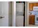 A laundry closet with a stacked washer and dryer unit, conveniently located in the kitchen area at 3909 45Th W Ter # 102, Bradenton, FL 34210