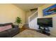 Comfortable living area with a sofa, chair, a TV, and staircase access to the upper level at 3909 45Th W Ter # 102, Bradenton, FL 34210