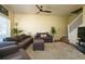 Spacious living room featuring comfortable seating, ceiling fan, and staircase to upper level at 3909 45Th W Ter # 102, Bradenton, FL 34210