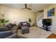 Inviting living room featuring neutral tones, a ceiling fan, and staircase access to the upper level at 3909 45Th W Ter # 102, Bradenton, FL 34210