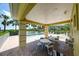 Covered pool-side area with several tables and chairs, for poolside recreation at 3909 45Th W Ter # 102, Bradenton, FL 34210