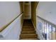 Carpeted staircase with white railings, leading to the upper level of the home at 3909 45Th W Ter # 102, Bradenton, FL 34210