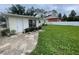 The backyard shows a door leading inside, lawn, and a partial view of a white fence at 4611 W Mcelroy Ave, Tampa, FL 33611