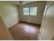 A simple bedroom featuring tile flooring, a ceiling fan, and a window with an outside view at 4611 W Mcelroy Ave, Tampa, FL 33611