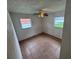 Smaller bedroom showcasing two windows, tiled floors, and a neutral color scheme at 4611 W Mcelroy Ave, Tampa, FL 33611