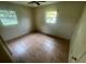 This bedroom features tile floors, natural light from two windows, and a ceiling fan at 4611 W Mcelroy Ave, Tampa, FL 33611