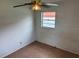 Simple bedroom featuring tiled flooring, natural light from a window, and a standard ceiling fan at 4611 W Mcelroy Ave, Tampa, FL 33611