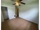 Simple bedroom with tiled floors, a closet with sliding doors, and a standard ceiling fan at 4611 W Mcelroy Ave, Tampa, FL 33611