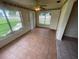 The living room features tile floors, a ceiling fan, and many windows for natural light at 4611 W Mcelroy Ave, Tampa, FL 33611