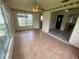 Spacious living area with tile floors, abundant natural light, and access to other rooms at 4611 W Mcelroy Ave, Tampa, FL 33611